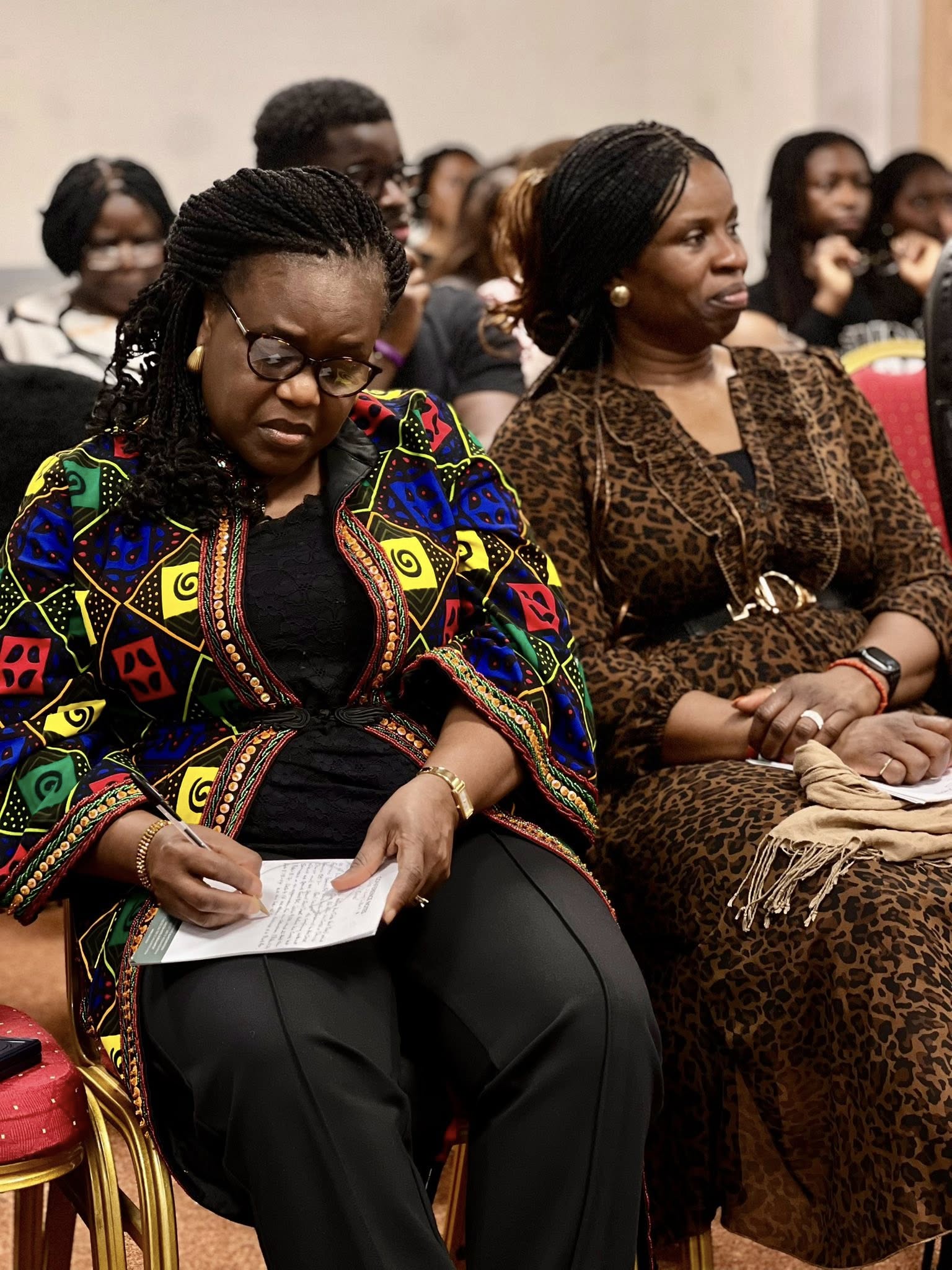 Congregation members taking notes during teaching